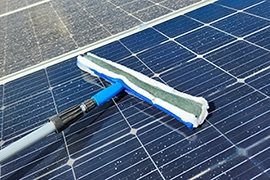 A view of solar panels against a blue sky.