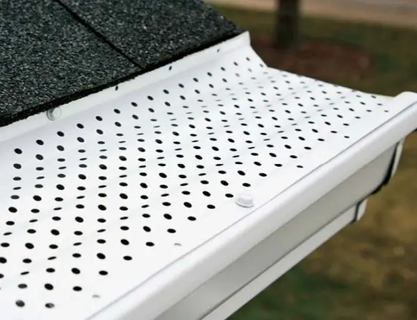 A white gutter guard installed on a home by Window Genie.