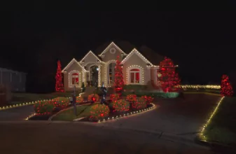 House lit up with Christmas lights professionally installed by Window Genie