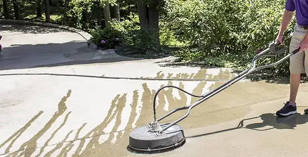 Professional-grade pressure washer–surface cleaner being used on exterior concrete walkway.