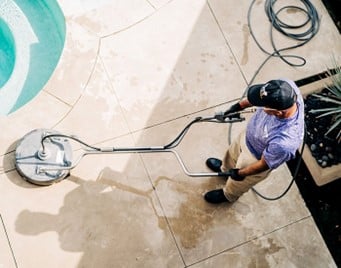 Window Genie Tech performing concrete cleaning