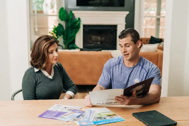 Window Genie service professional consulting with a customer.