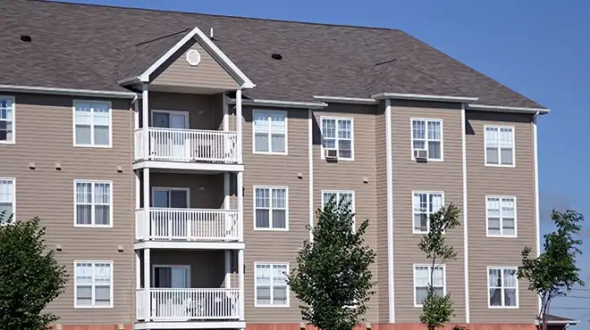 A four-story apartment building with panel siding.