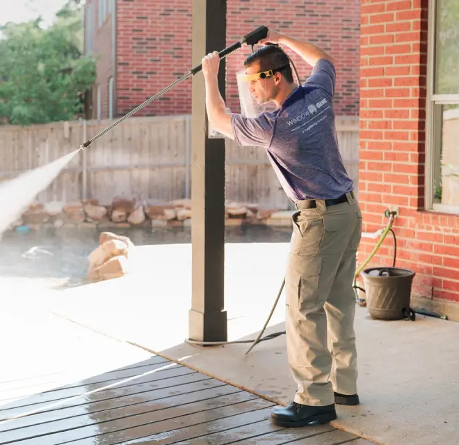 Window Genie service professional cleaning a deck.