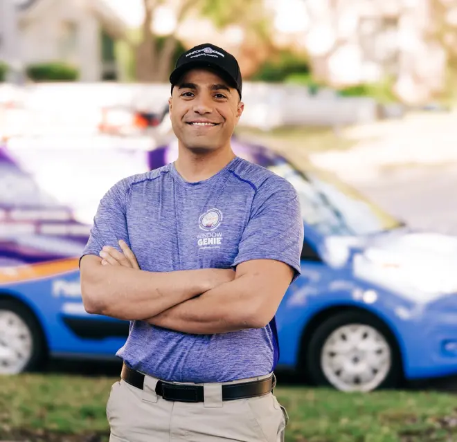 Window Genie service professional smiling outside of a customer's home.