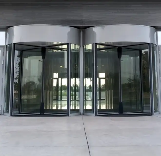 Freshly sealed concrete walk in front of the revolving doors to a commercial building.
