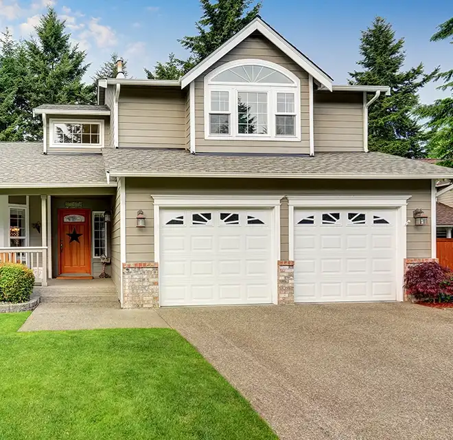 Home with freshly sealed concrete driveway.