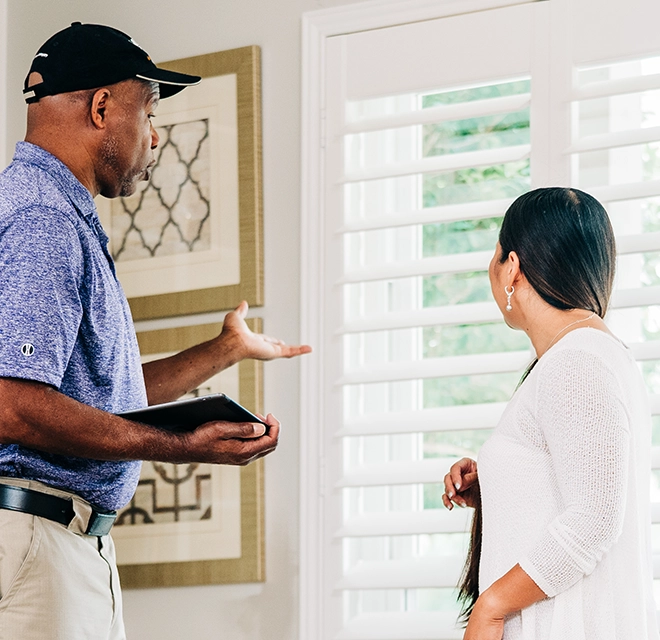 Window Genie technician showing a customer her options.