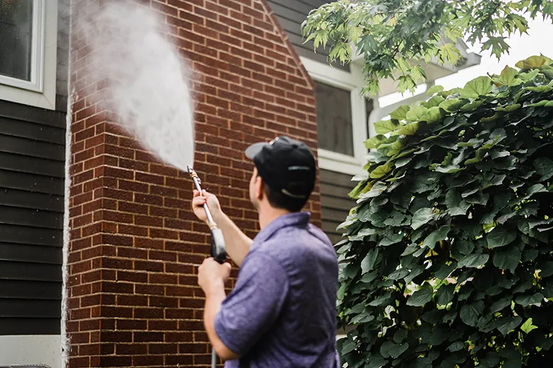 Window Genie professional pressure washing a home