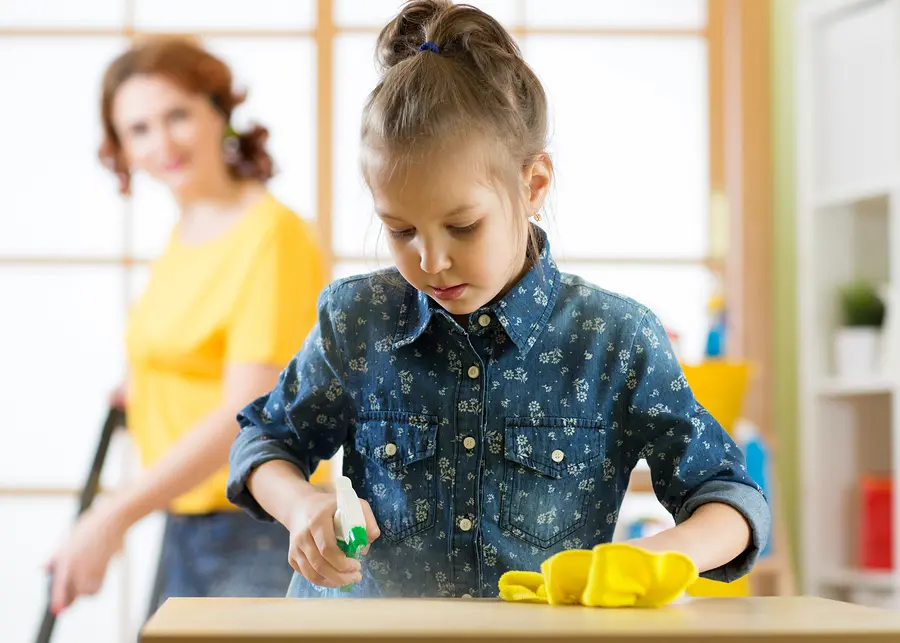 A girl cleaning counter.