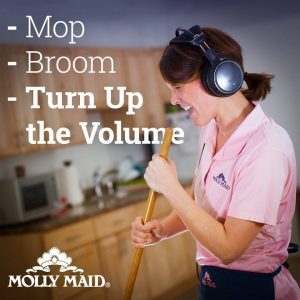 A Molly maid mopping and enjoying the music.