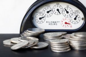 Energy meter and quarters on a table.