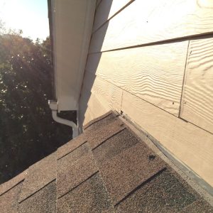 The seam where an exterior wall of a house meets a lower roof.