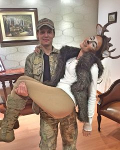A man and a woman dressed like Deer and hunter.