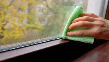 Wiping the stains of the window.
