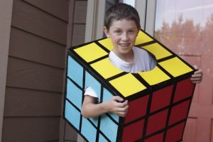A young boy wearing a Rubik's Cube costume.