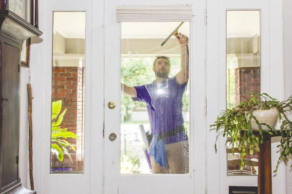 A man cleaning a window