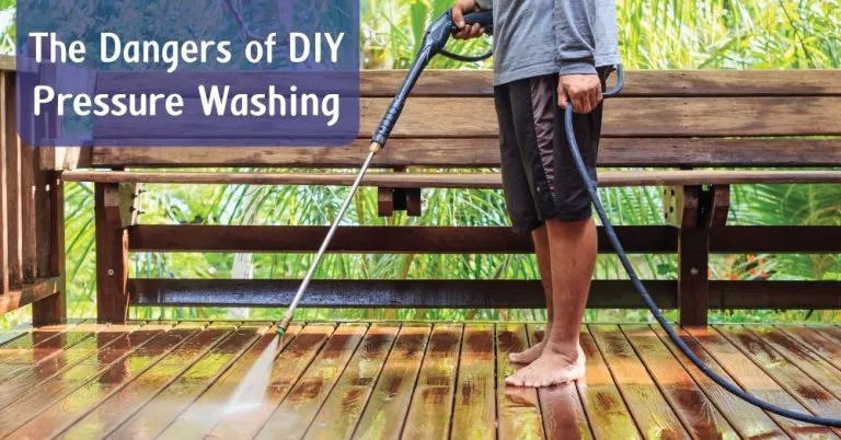 Person pressure washing a deck with text reading The Dangers of DIY Pressure Washing.