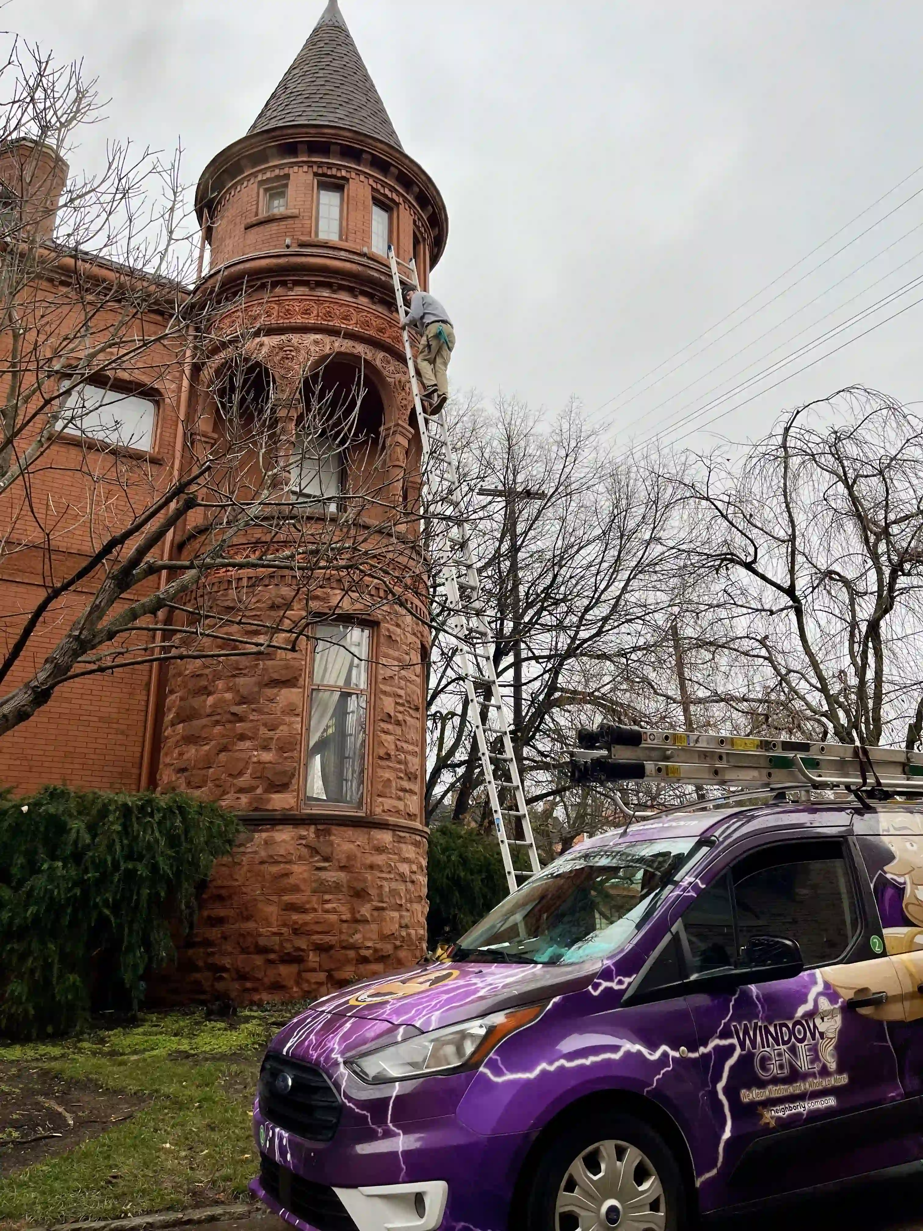 Technician safely cleaning gutters in Charlotte.