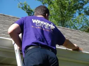 Window Genie technician cleaning a gutter